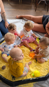 when do babies start playing with other babies?