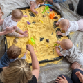 when do babies start playing with other babies?