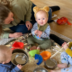 when do babies play with other babies