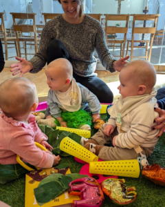 when do babies play with other babies