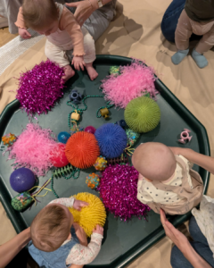when do babies play with other babies